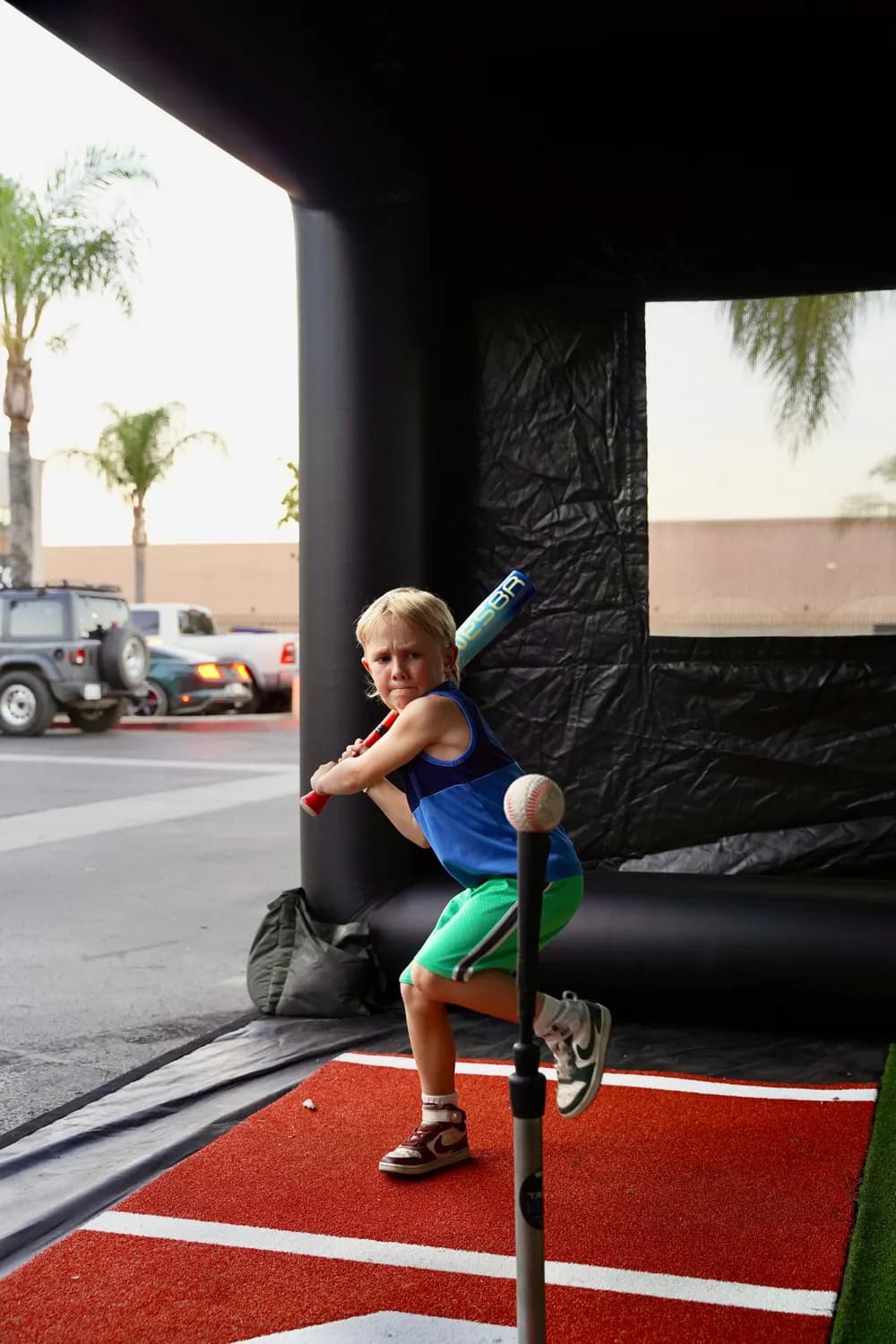 A young hitter loading up at the tee inside the On Deck hit house